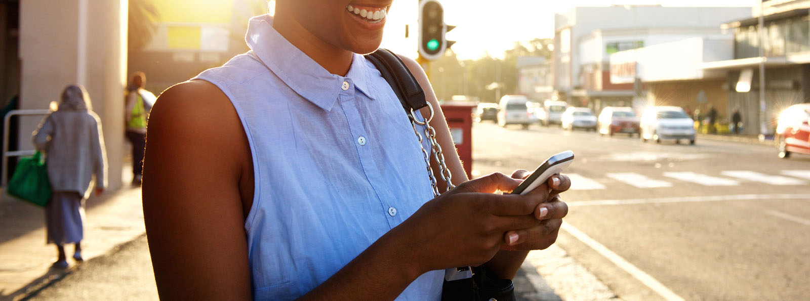 smiling woman holding cellphone