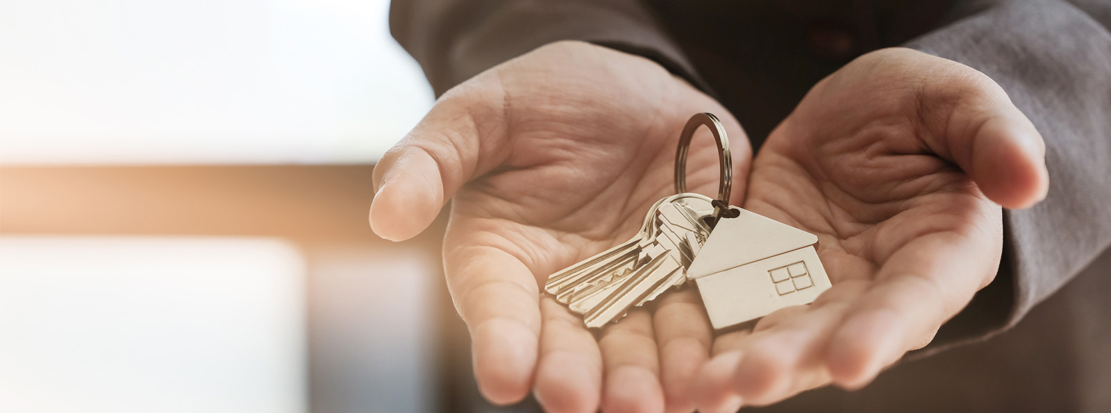 man holding house keys in his hands