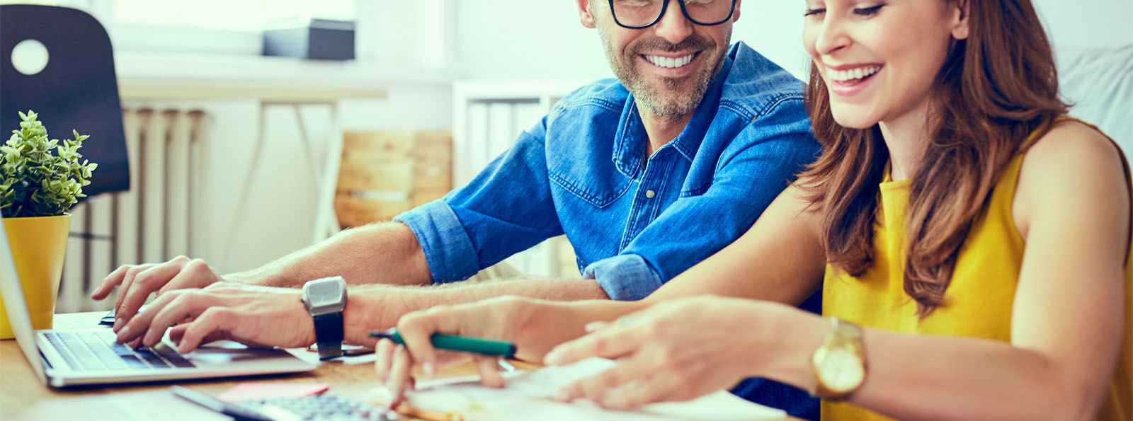 husband and wife happily reviewing finances