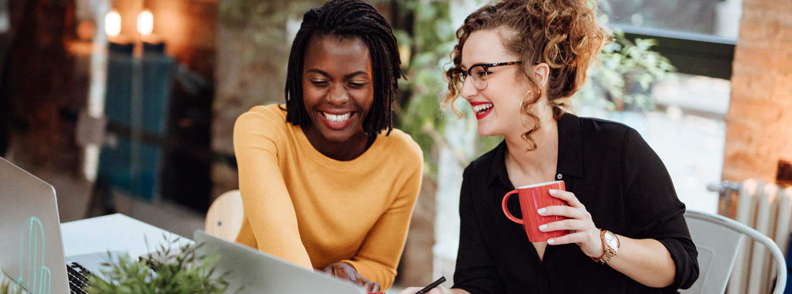 two women happily working side-by-side