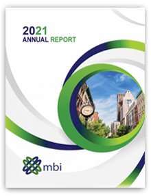 2021 Annual Report Cover. Green and blue gradient encircling a street shot of downtown Louisville, KY.