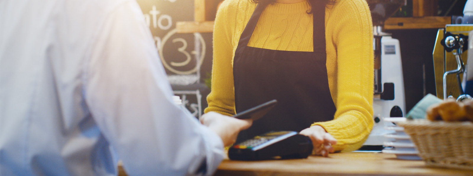 person making transaction at a store with their credit card